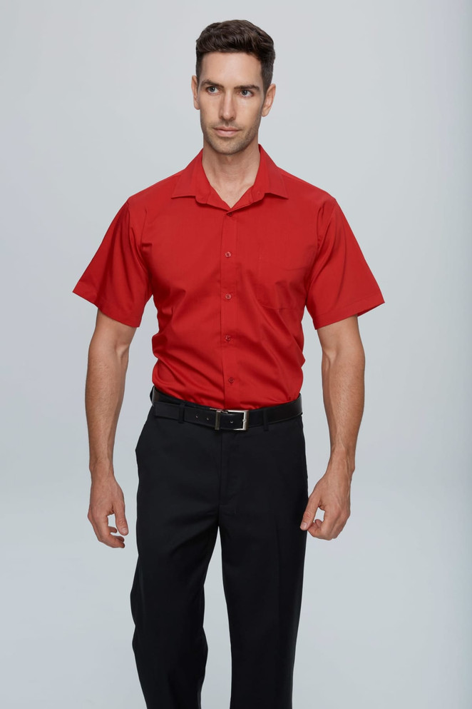 A short sleeve, button-up shirt in vibrant red, modelled with black trousers. The shirt features a logo.