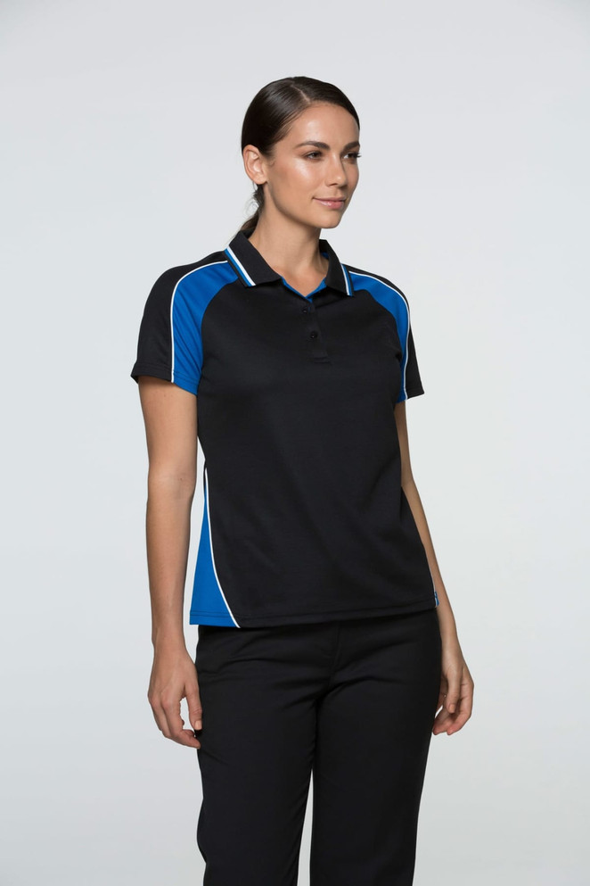 A woman wearing a black polo shirt with blue accents and white detailing, standing against a light background.