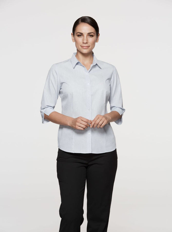 A light blue button-up shirt with 3/4 sleeves, featuring a logo on the chest.