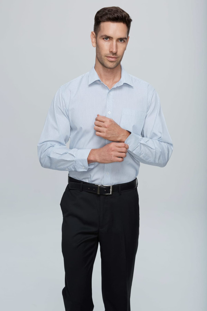 A long sleeve button-up shirt in light blue, featuring a logo, worn by a model against a neutral background.
