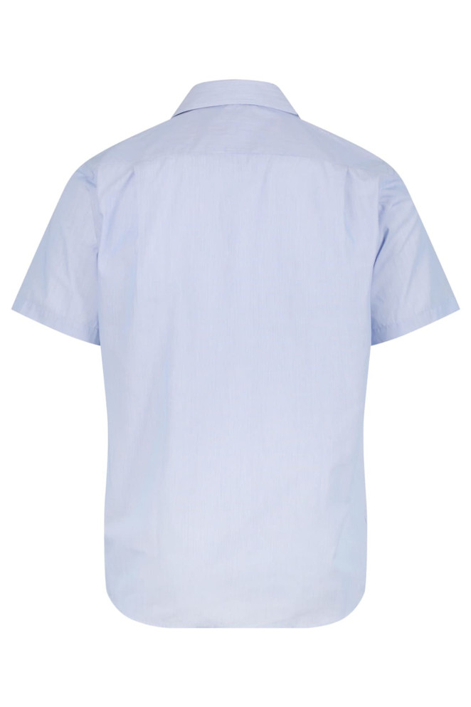 A short-sleeve button-up shirt in light blue with a simple design and a discreet logo.