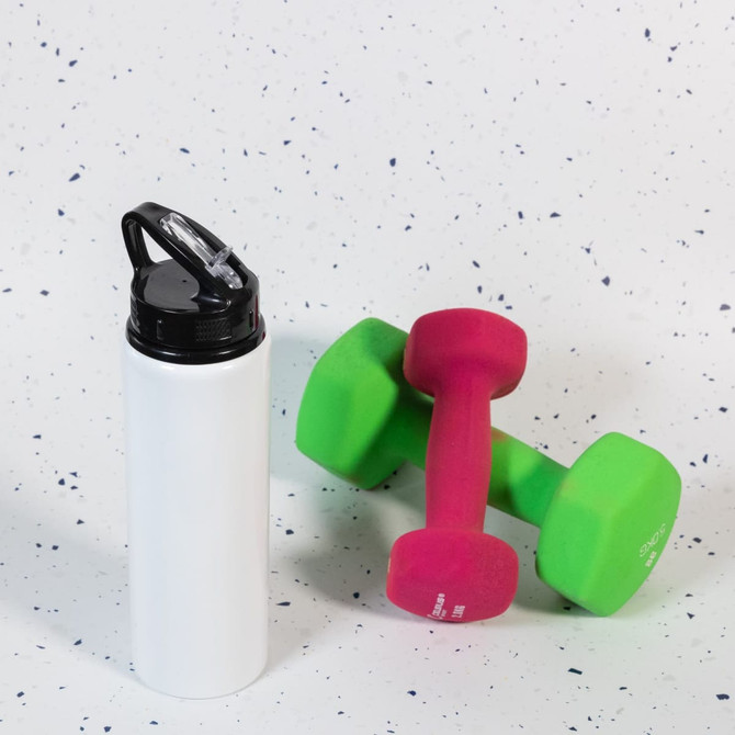 A drink bottle with a flip straw lid in white, alongside pink and green dumbbells. The bottle features a logo.