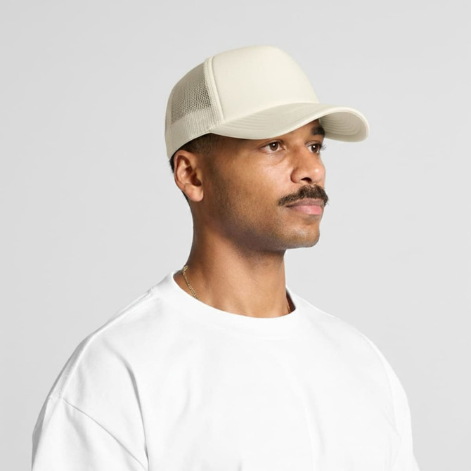 A cream-coloured foam trucker cap with a mesh back, worn by a man with a moustache.