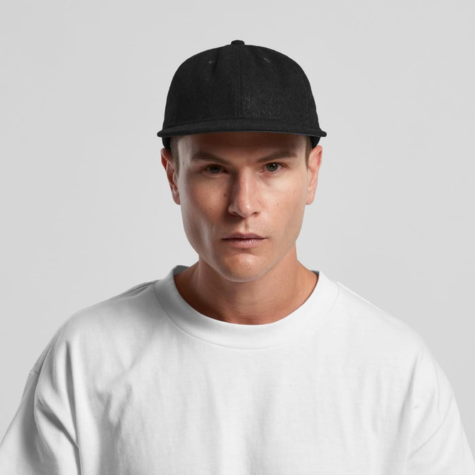 A black wool cap on a model wearing a white t-shirt. The cap has a logo on the front.