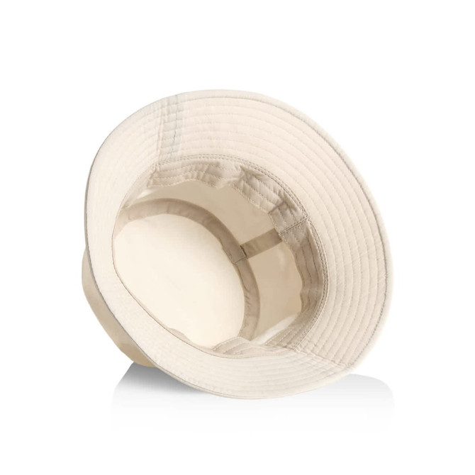 A cream nylon bucket hat with a wide brim and an interior lining. It features a logo inside.