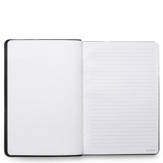A black notebook with blank pages inside, featuring a lined page on one side and a smooth page on the other.