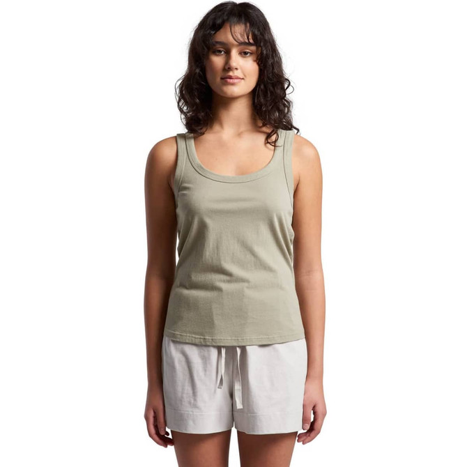 A soft, sage green singlet with a classic fit, paired with white shorts. The model stands facing forward.
