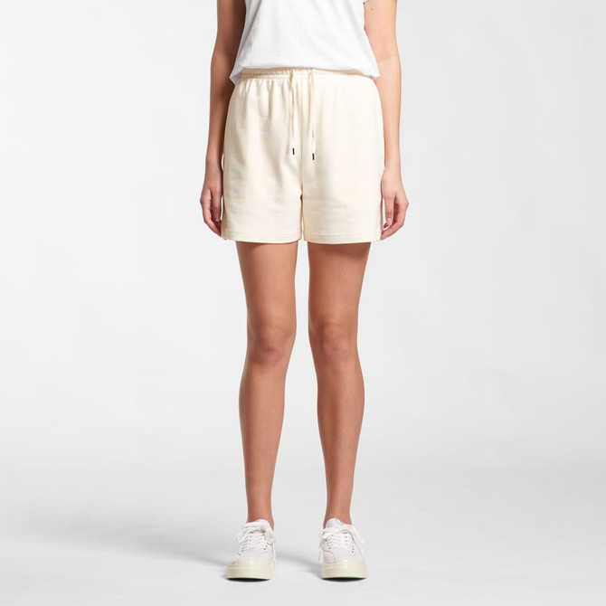 Cream-coloured sports shorts with an elastic waistband and drawstring, featuring a logo on the front.