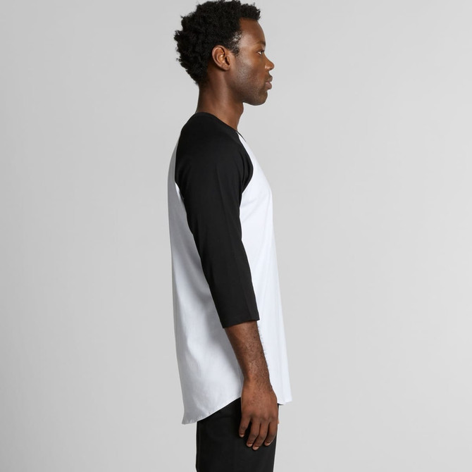 A side view of a raglan tee featuring a white body and black sleeves. The shirt has a logo on it.