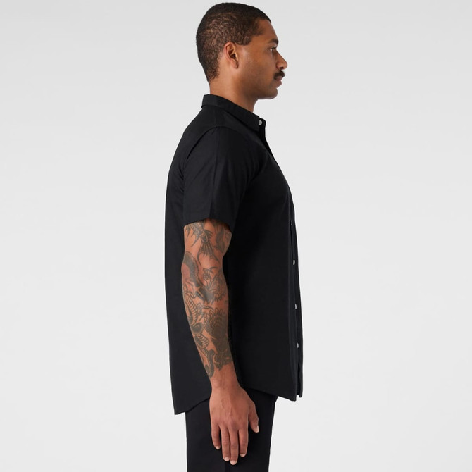 A black short-sleeve button-up shirt displayed from the side, featuring a sleek design and a fitted silhouette.
