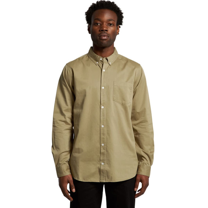 A button-up denim wash shirt in olive green, featuring long sleeves and a chest pocket. It has a logo on the fabric.