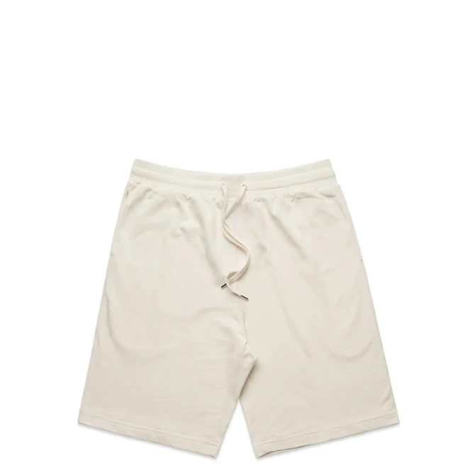 Light beige sports shorts with an elastic waistband and drawstring, featuring a logo.