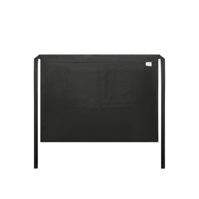 A black half apron featuring a spacious front pocket and ties for fastening, with a small logo at the corner.