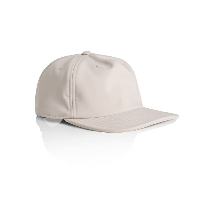 A beige cap with a curved brim, featuring a logo on the front and a smooth texture.