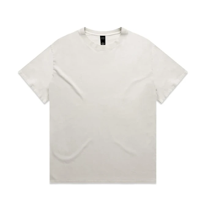 A heavy faded tee in a light cream colour, featuring a crew neckline and short sleeves, with a logo on the label.