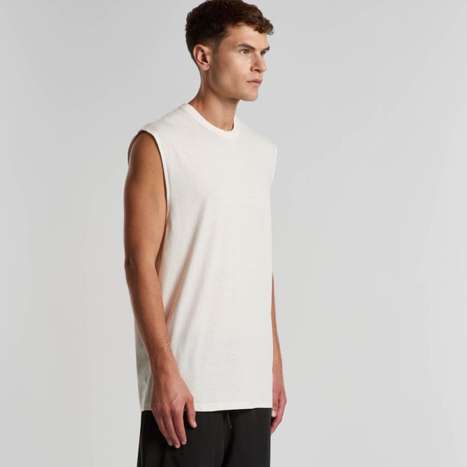 A cream sleeveless tank top displayed on a model, featuring a casual and relaxed fit. It has a logo.
