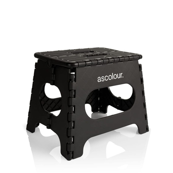 A black folding stool with a textured top and cut-out handles, featuring a logo on one side.