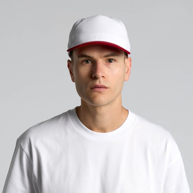 A two-tone cap in white and red with a logo, worn by a person in a white T-shirt.