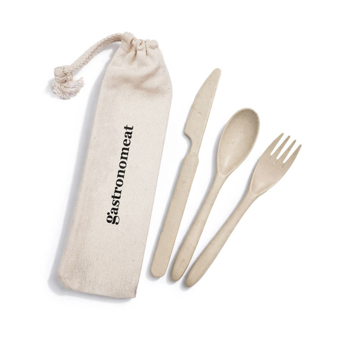A set of eco-friendly cutlery in beige, featuring a fork, knife, and spoon, stored in a calico pouch with a logo.