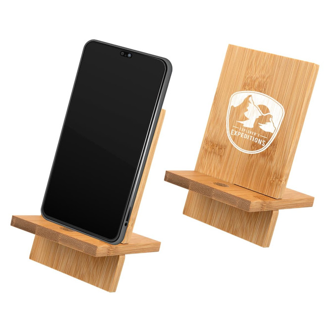 A bamboo phone stand displaying a smartphone, featuring a logo on the back. Natural wood finish.