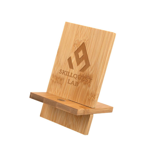 A bamboo phone stand with a natural finish and a logo engraved on its surface.