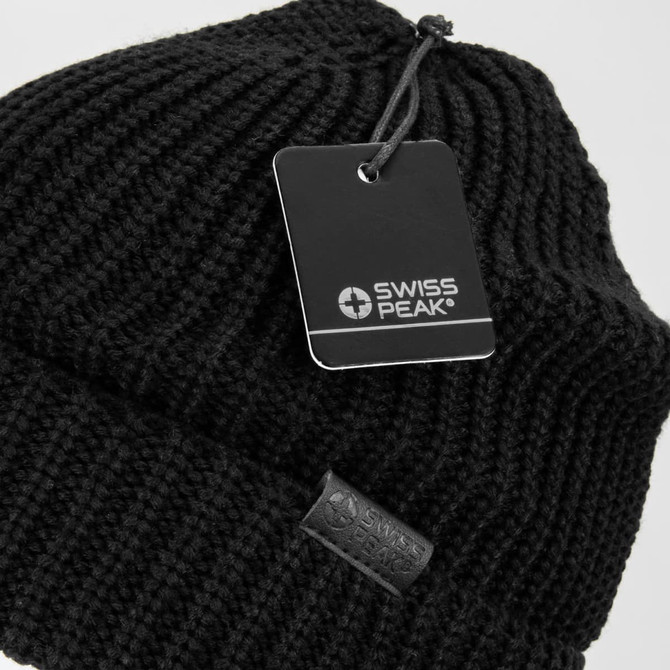 A black knitted beanie with a tag and a small logo on the side.