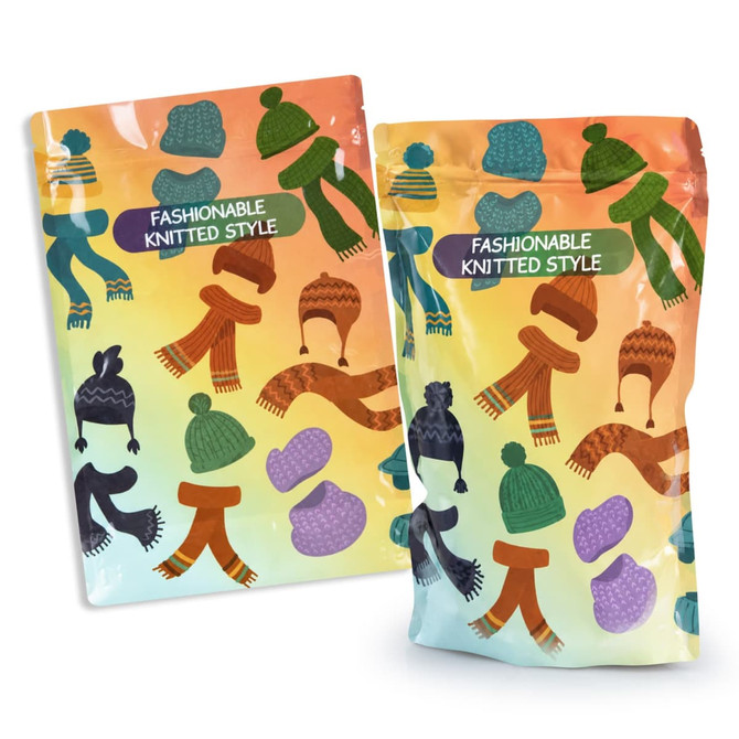 A foil stand-up pouch in pastel colours featuring patterns of hats and scarves. The pouch has a logo.