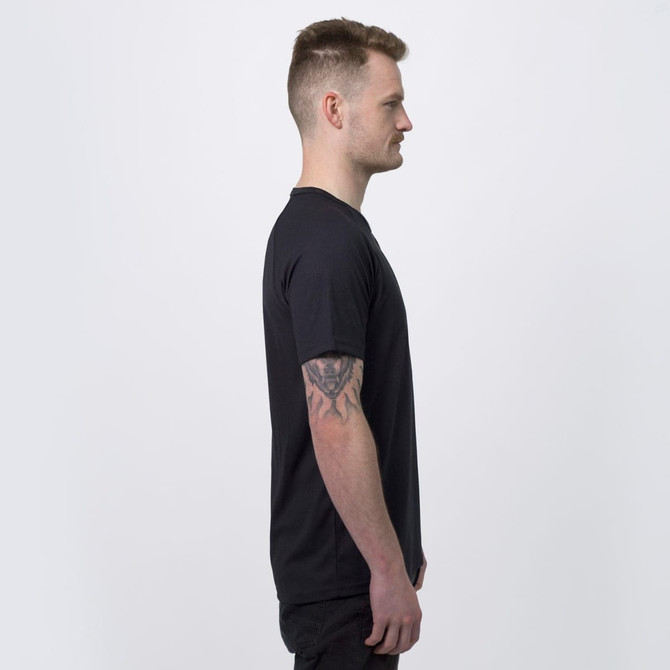 A side view of a man wearing a black TRENDSWEAR Agility men's sports T-shirt. The shirt has a logo on it.