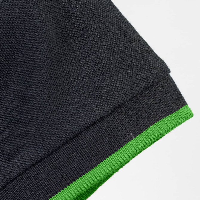 A black polo shirt featuring a green trim on the collar and sleeves, with a logo present.