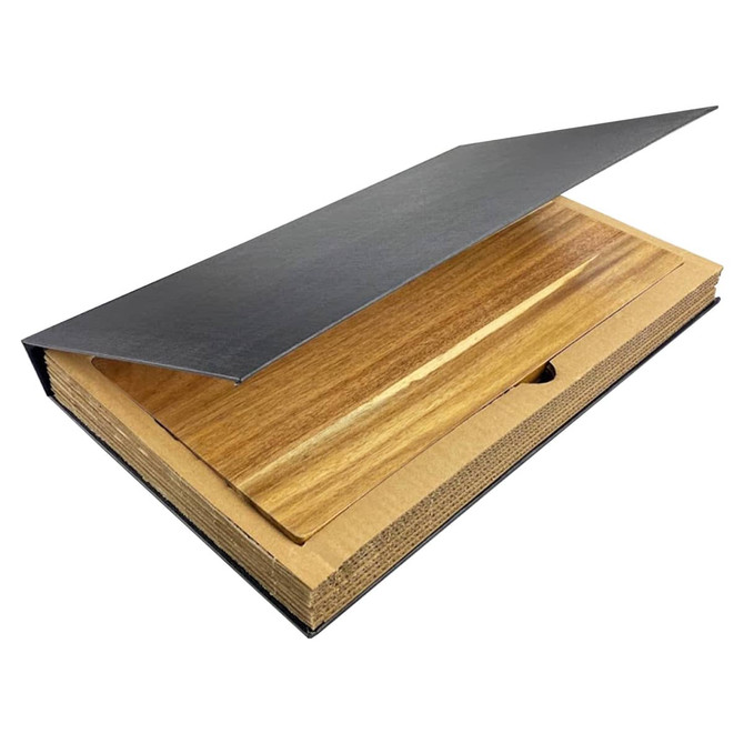 A wooden cheeseboard with a black metal cover, featuring a smooth surface and a natural finish.