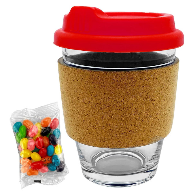A glass coffee cup with a red lid and cork band, accompanied by a packet of colourful jelly beans.