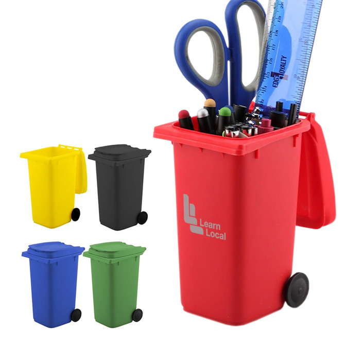 A red wheelie bin pen holder filled with pens, scissors, and a ruler, alongside three other coloured bins: yellow, black, and green.