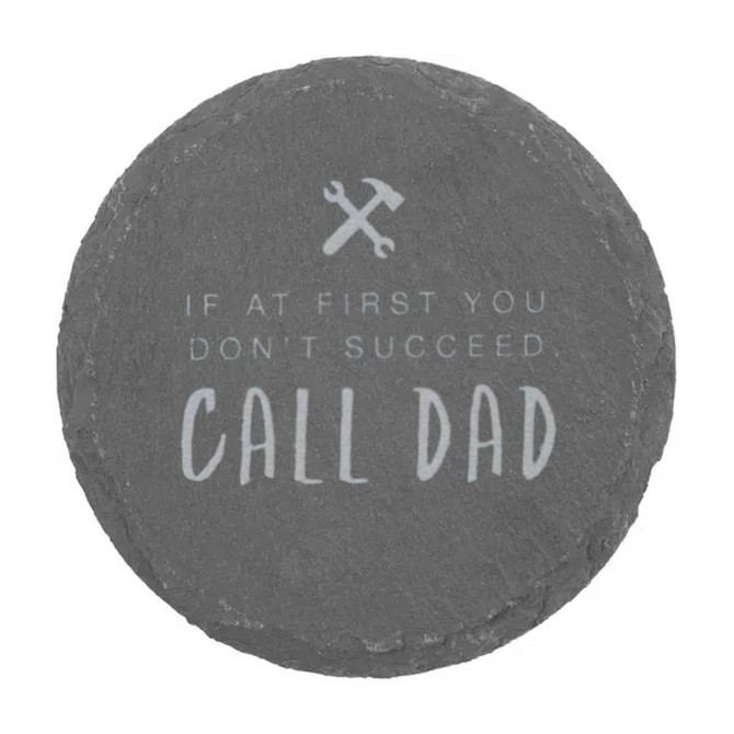 A round slate coaster featuring grey tones and an inscription about calling Dad for help.