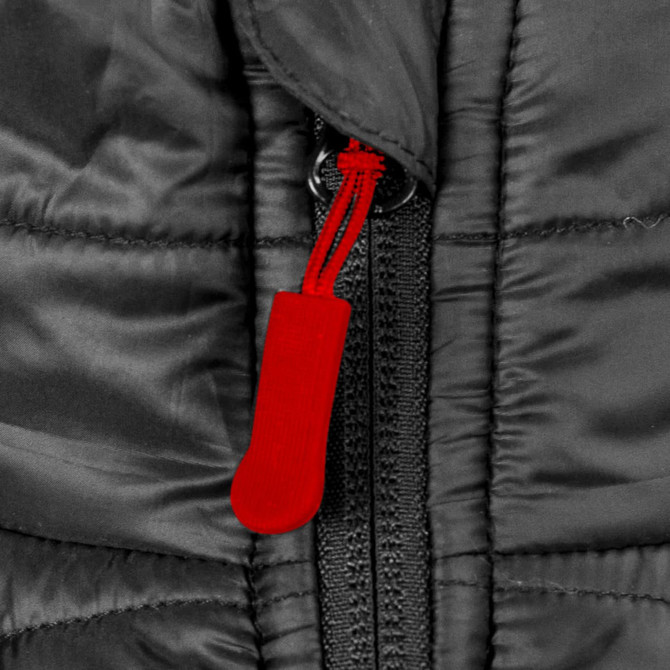 A close-up of a black puffer vest featuring a red zip pull, highlighting the zipper detail.