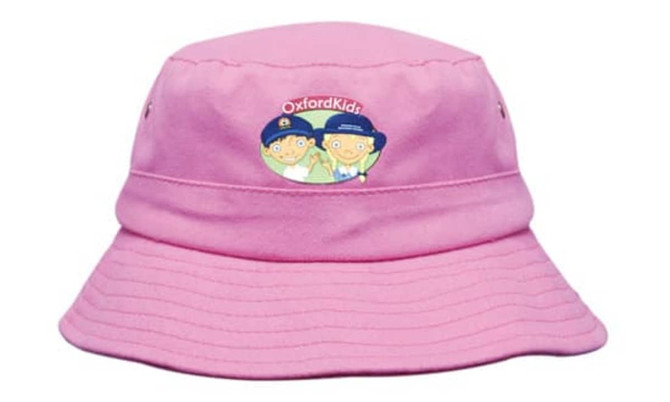 A pink bucket hat featuring a logo, designed for infants, with a soft twill fabric and a wide brim.