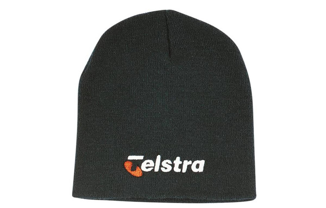 A rolled down black acrylic beanie featuring a logo on the front.