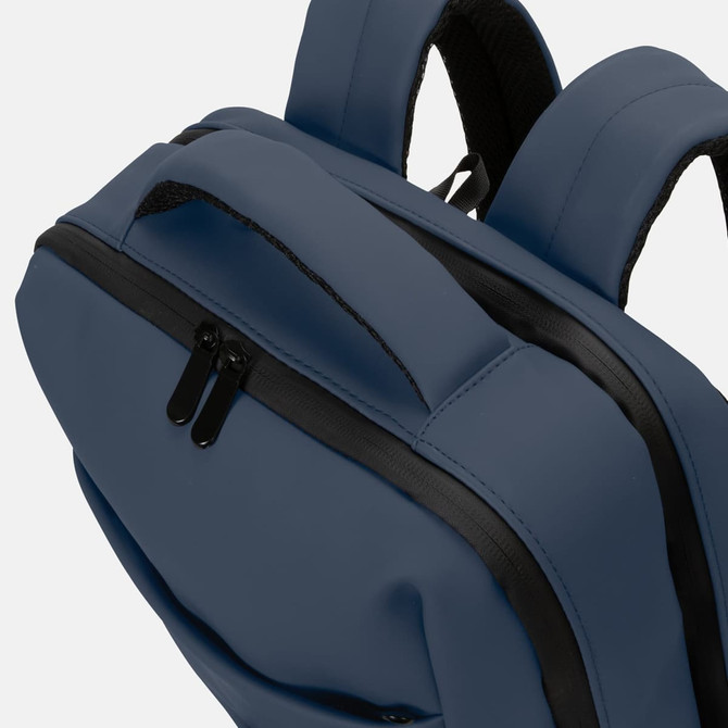 A soft-touch daily backpack in a deep blue colour, featuring black zippers and straps.