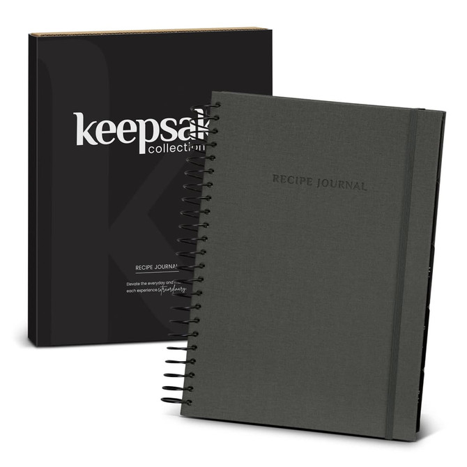 A dark grey spiral-bound recipe journal with a black box featuring a logo.