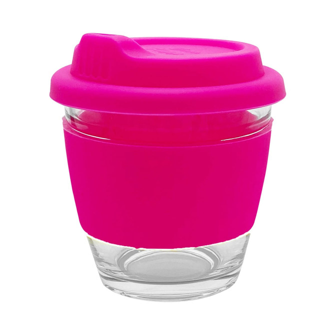 A reusable coffee cup made of glass with a bright pink silicone sleeve and lid. It features a logo.