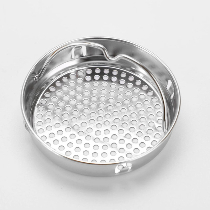 A stainless steel perforated cooking tray with a single handle and multiple holes for steam circulation.