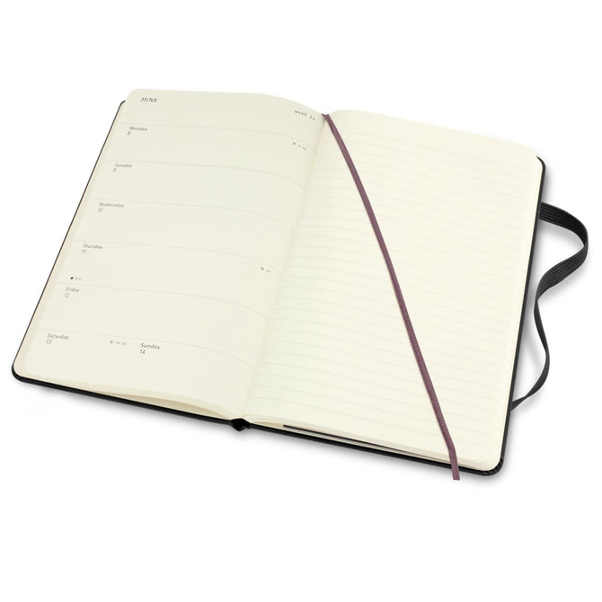 An open Moleskine 2026 planner in black, featuring week-to-week layouts and a ribbon bookmark.