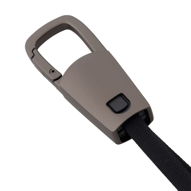 A brown ClipIt Carabiner Cable features a retractable strap and a button mechanism. It includes a logo on the surface.
