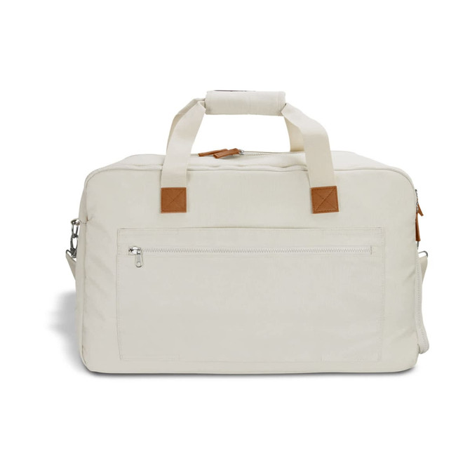 A cream duffle bag with leather accents and a front zip pocket, featuring dual handles and a shoulder strap.