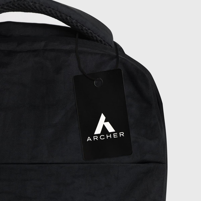 A black backpack with a textured surface and a hanging tag featuring a logo.