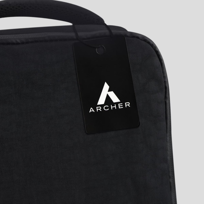 A black travel backpack with a tag featuring a logo. The fabric appears textured and durable.