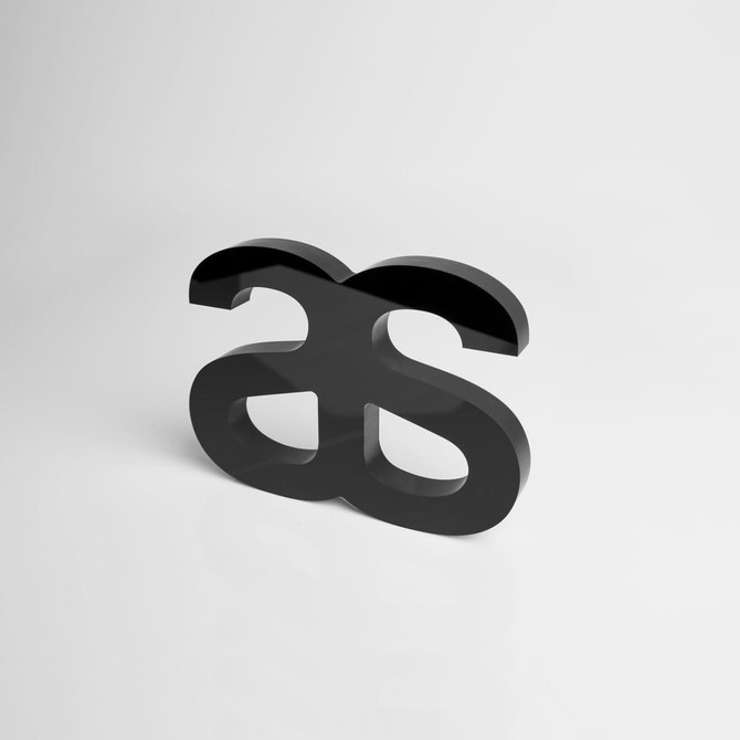 A black acrylic plaque featuring an abstract design with a logo, designed for awards and trophies.