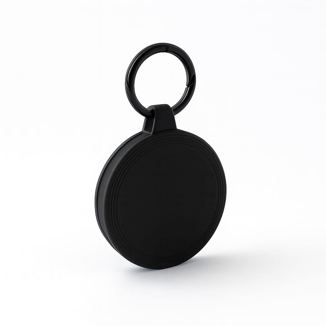 A black keyring with a round pendant design, featuring textured grooves around the edge.