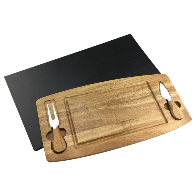 A wooden cheeseboard with two stainless steel knives on a black background.