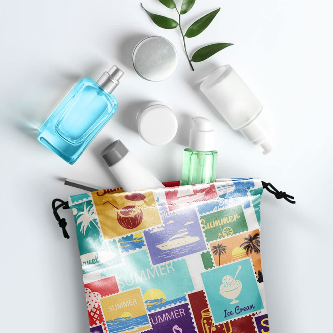 A large satin gift bag with a colourful print, containing various cosmetic and skincare bottles.