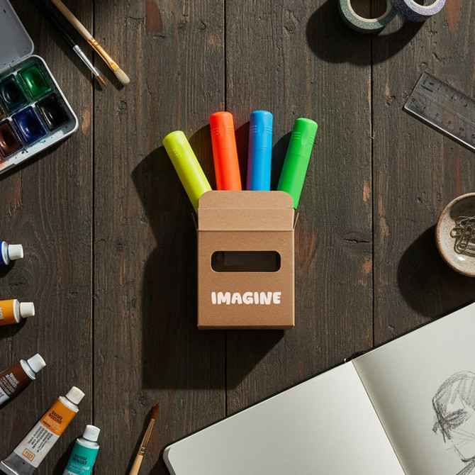 A triangle highlighter set in a box with four highlighters: pink, green, orange, and yellow, on a wooden surface.